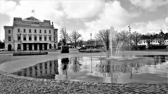 Black and white photo with the beautiful theater in the park, with the fountain and plants in Gothenburg, Sweden