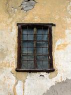 Old window of the building with yellow wall