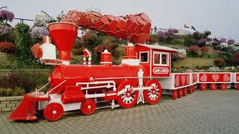 photo of a red and white steam locomotive in Dubai