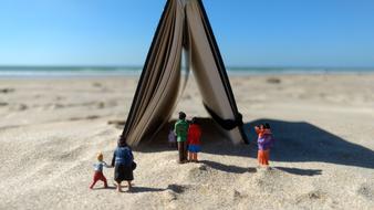 a tent with people and sand