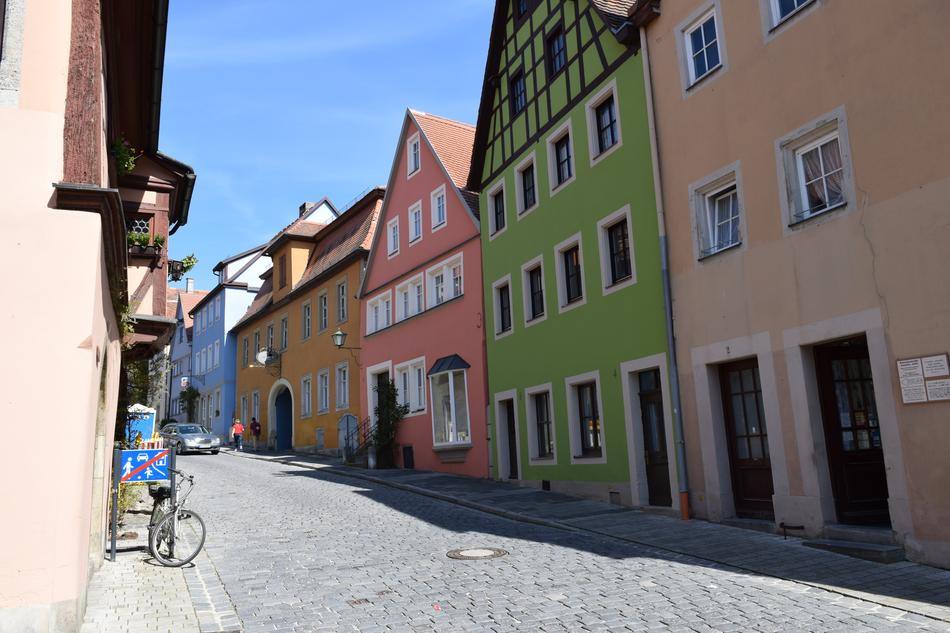 Car and bike, on the beautiful street in Germany, with the colorful houses, in sunlight