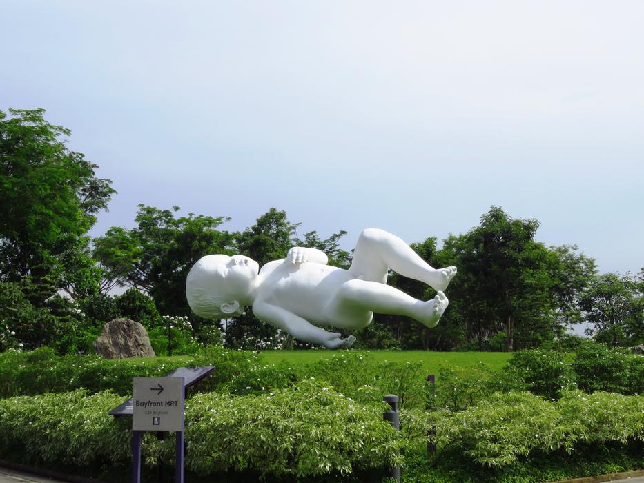 child sculpture green trees