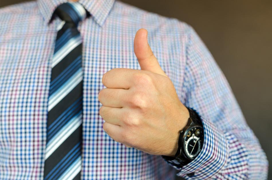 Male in shirt with tie showing like sign