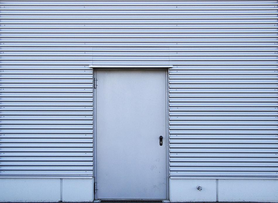 gray door and profile sheets on the garage wall