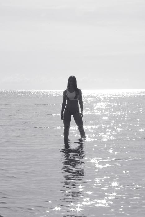 distant view of a posing girl in the water