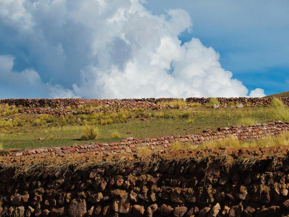 land of green grass and clouds