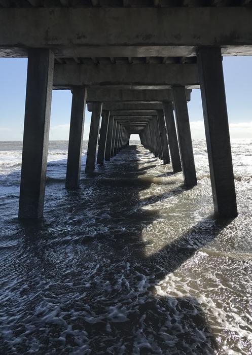 under the pier on the ocean
