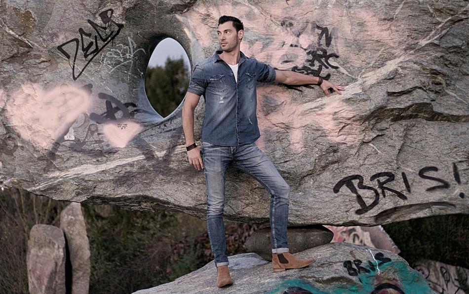 Man, near the colorful rocks, with the paintings