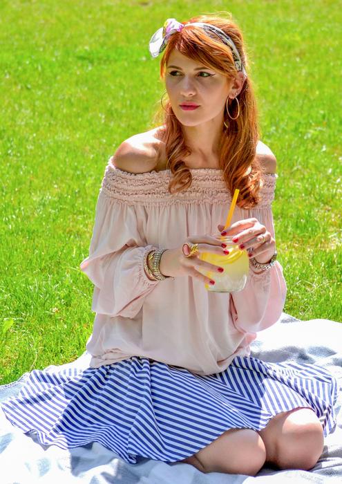 Beautiful Girl posing with cold drink in Park