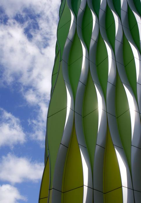 contemporary facade covered with tile at cloudy sky