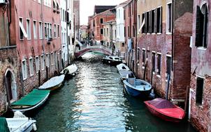 boats along houses on a canal in venice