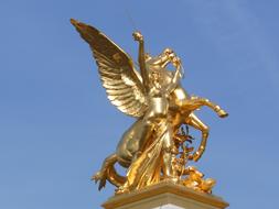 golden statue on alexandre iii bridge