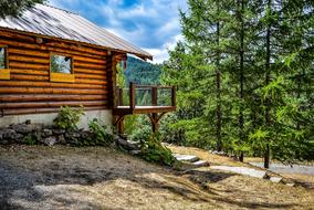 Beautiful wooden house on the hill among the green trees