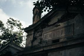 sculpture of an angel on a tombstone in a catholic cemetery