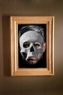 portrait of a man in a mask in a wooden frame