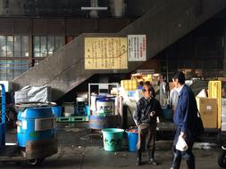 People at the fish market, near the building