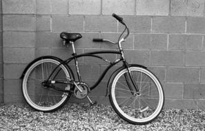 Black and white photo of the retro bicycle, on the wall