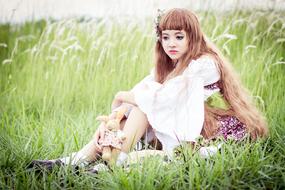 girl model in tall green grass
