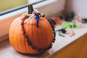 Cute, orange pumpkin, with the colorful decorations