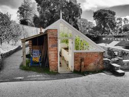 Beautiful and colorful greenhouse, among the landscape in black and white colors, in England