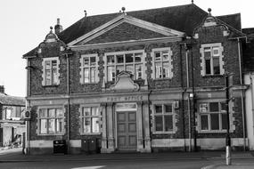 Black and white photo of the old post office on the street