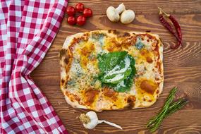 pizza with vegetables on a cutting board