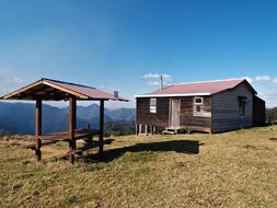 Beautiful hut on the green mountain, with the beautiful panorama of mounains