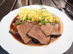 meat with sauce and potatoes