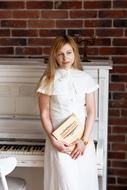 white piano and woman in white dress