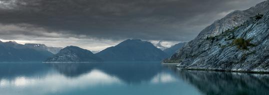 panorama of gray mountains and water