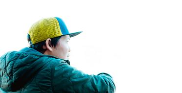 man in a green jacket in profile on a white background