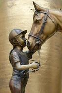 Girl petting Horse head, sculpture