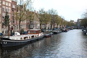 moored boats along the canal in Amsterdam, Netherlands
