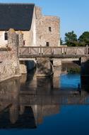 stone building with a bridge by the water