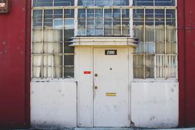 Old door of the colorful building, with the windows
