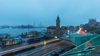 Beautiful and colorful port of Hamburg, Germany, with the colorful lights in motion, under the clouds