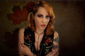 Redheaded girl with a tattoo on her shoulder