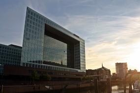 mirrored building in the harbor at dusk