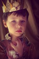 Portrait of the cute prince boy, with the colorful crown