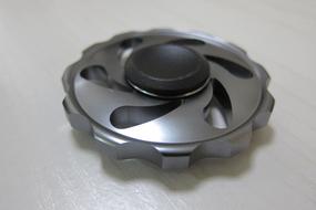 Shiny, metallic fidget spinner, with the shadow, in light