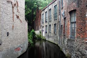 photo of the canal between medieval buildings in Bruges, Belgium