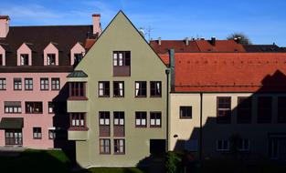 Colorful and beautiful houses in the historic center of Augsburg, Germany, at blue sky with clouds on background