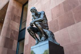 the Thinker, Sculpture at tiled wall