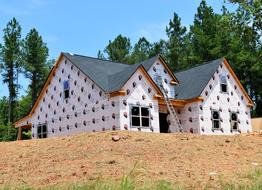 Beautiful and colorful home construction on the hill, with the green plants