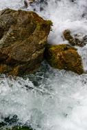 The waves crashing against the rocks