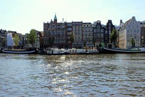 boats moored at historical waterfront, netherlands, Amsterdam