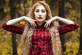 portrait of a girl in the autumn forest with a blurred background