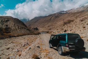 green car in the mountains