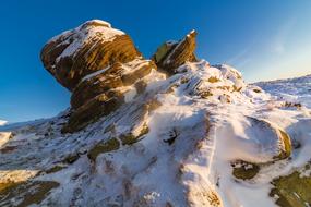 snowy rock with blue sky