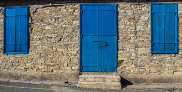 Beautiful, old building with the blue, wooden doors and window shutters, in Kato Drys, Cyprus, Greece